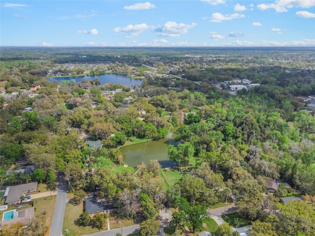 bird's eye view with a water view and a wooded view