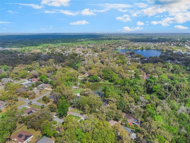 drone / aerial view with a water view and a wooded view