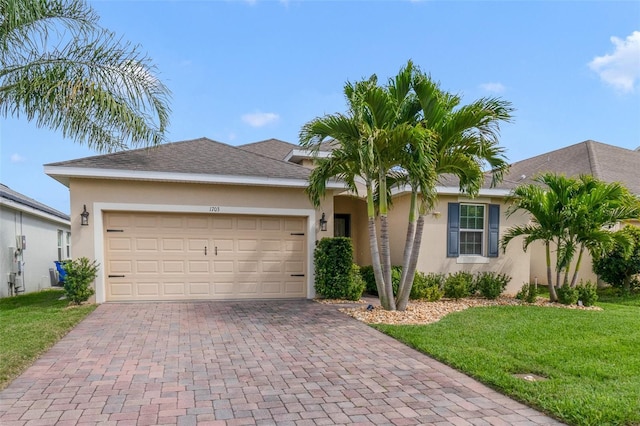 single story home featuring a garage, a front lawn, decorative driveway, and stucco siding