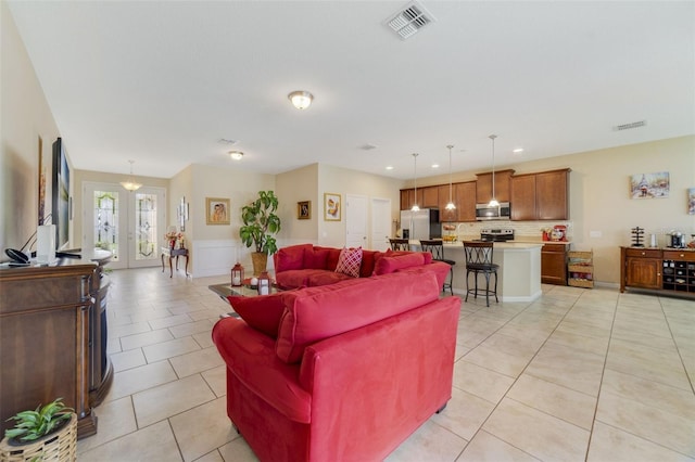 living area with light tile patterned floors, french doors, visible vents, and recessed lighting