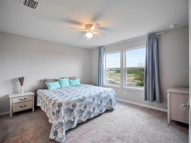 bedroom featuring carpet floors, a ceiling fan, visible vents, and baseboards