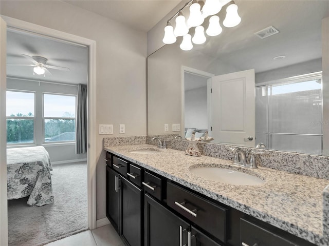 full bathroom featuring double vanity, a sink, visible vents, and connected bathroom