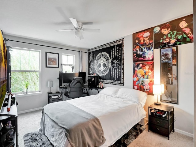 carpeted bedroom with ceiling fan and baseboards