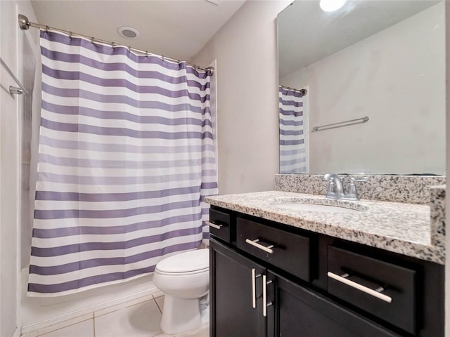 bathroom featuring a shower with shower curtain, vanity, toilet, and tile patterned floors