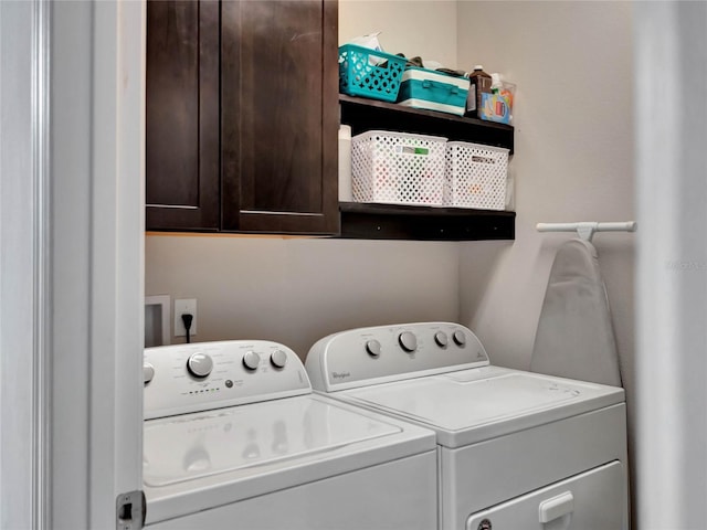 clothes washing area featuring cabinet space and independent washer and dryer