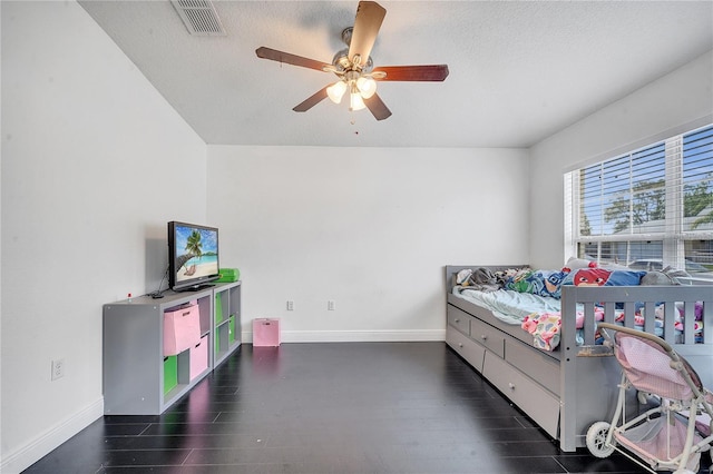 639 Mesilla Dr, Kissimmee, FL 34758 - bedroom with visible vents, a textured ceiling, wood finished floors, baseboards, and ceiling fan