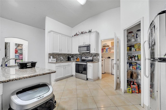 639 Mesilla Dr, Kissimmee, FL 34758 - kitchen featuring light tile patterned flooring, white cabinetry, stainless steel appliances, and light stone countertops