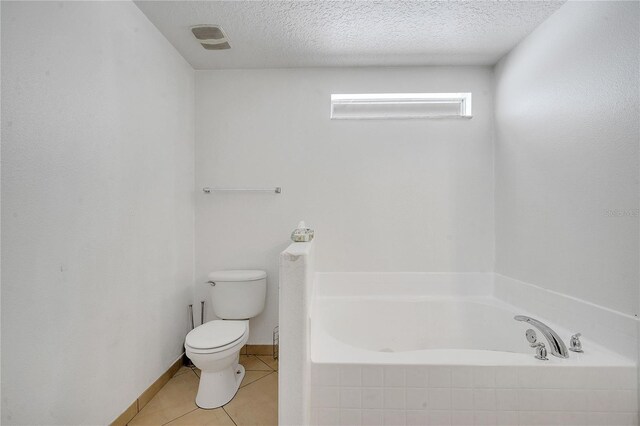 639 Mesilla Dr, Kissimmee, FL 34758 - full bathroom featuring a bath, visible vents, a textured ceiling, tile patterned floors, and toilet