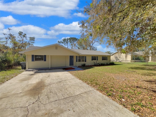 ranch-style home featuring driveway and a front lawn