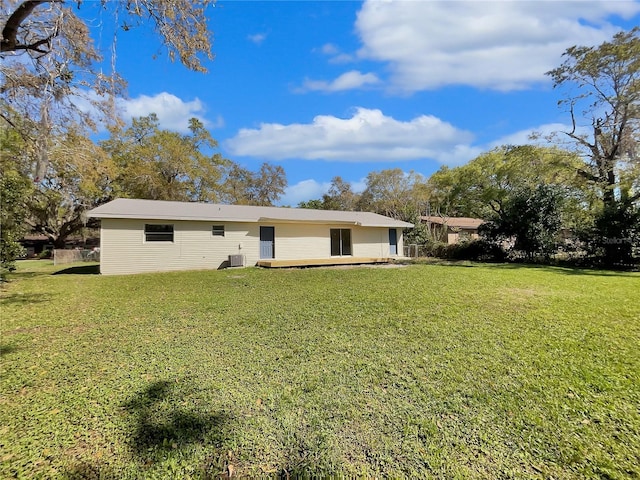 back of property with a lawn