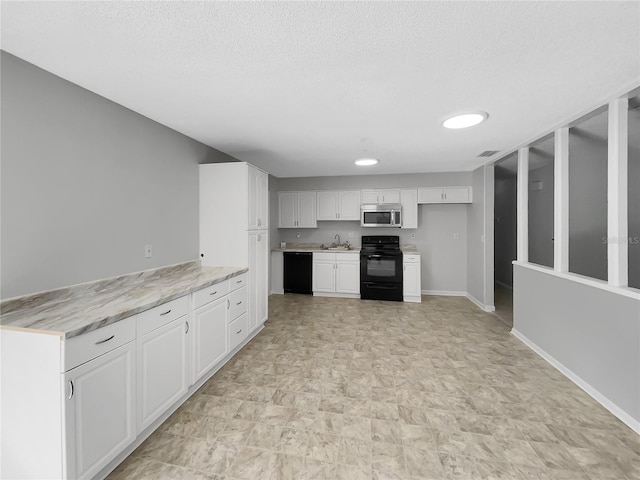 kitchen with baseboards, black appliances, a textured ceiling, and white cabinets