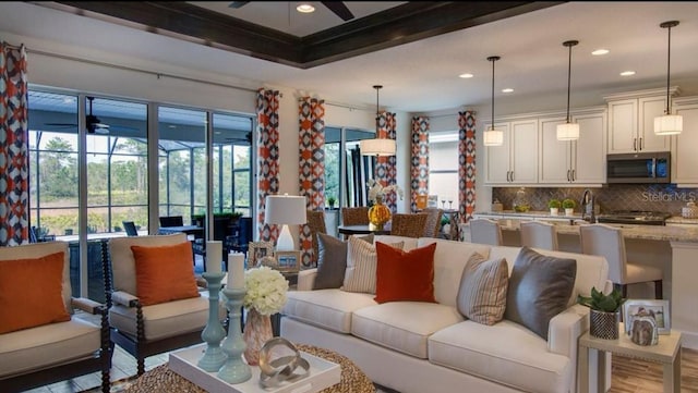 living room featuring a ceiling fan, recessed lighting, and wood finished floors