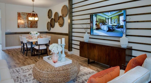 dining area featuring wainscoting and wood finished floors