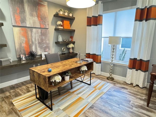 home office with a healthy amount of sunlight, baseboards, and wood finished floors