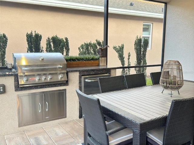 view of patio / terrace with a grill, outdoor dining area, and area for grilling