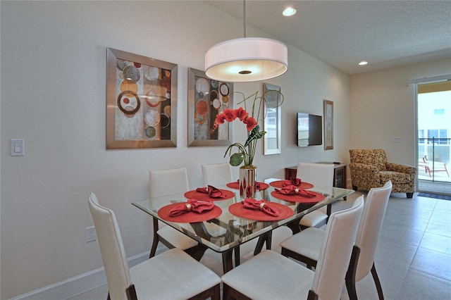 dining area featuring recessed lighting, tile patterned flooring, a textured ceiling, and baseboards