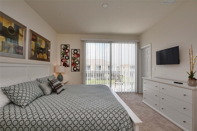 carpeted bedroom featuring access to outside and a decorative wall