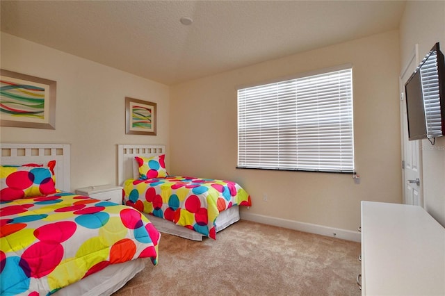 bedroom featuring a textured ceiling, carpet flooring, and baseboards