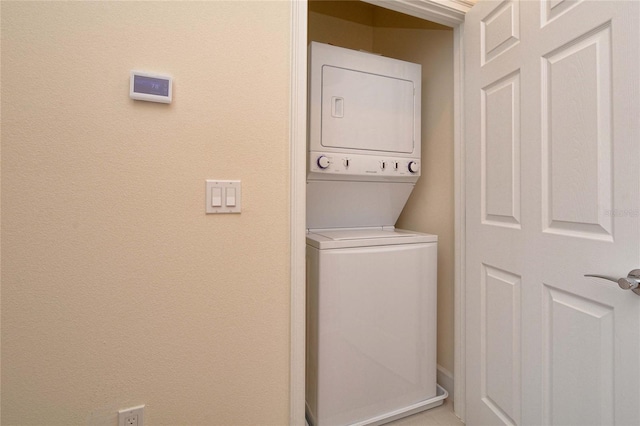 clothes washing area with stacked washer / dryer and laundry area