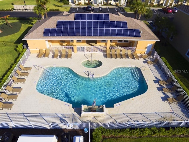 pool with a patio, outdoor dry bar, and fence