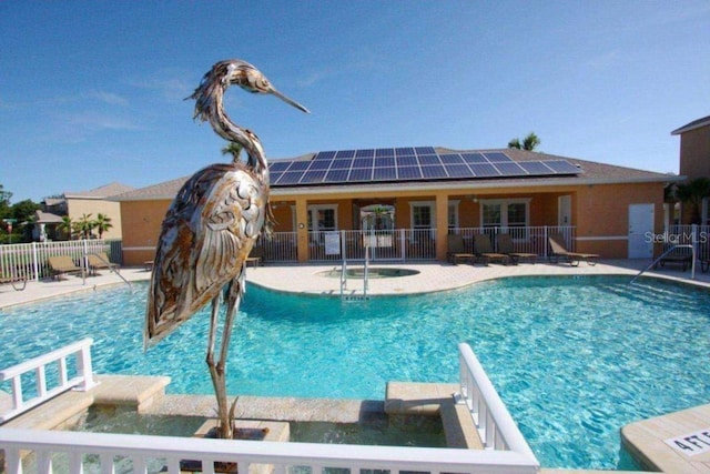 pool featuring fence and a patio