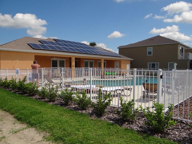 community pool with a patio and fence