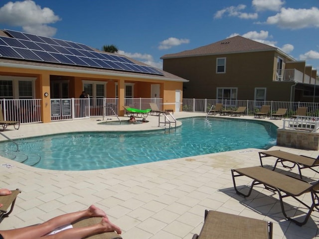 community pool featuring a patio area and fence