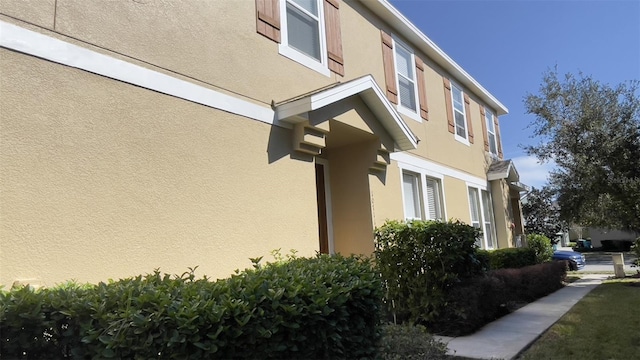 view of side of property featuring stucco siding