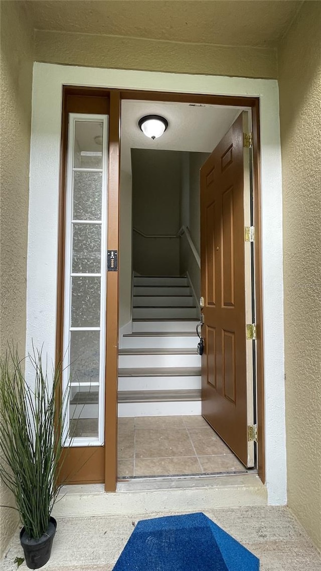 doorway to property featuring stucco siding