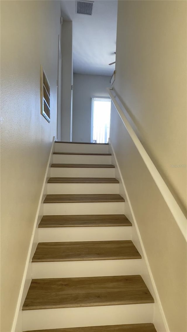 staircase featuring visible vents