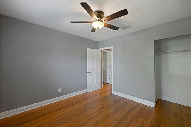 1111 Guernsey St, Orlando, FL 32804 - unfurnished bedroom featuring visible vents, baseboards, wood finished floors, and a closet