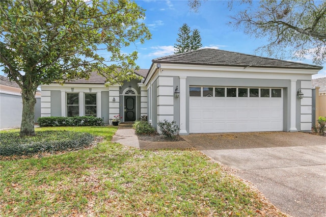 single story home with stucco siding, concrete driveway, an attached garage, and a tiled roof