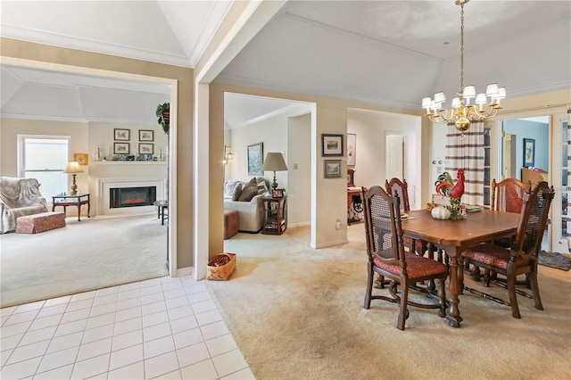 dining space featuring light tile patterned floors, lofted ceiling, a warm lit fireplace, crown molding, and light colored carpet