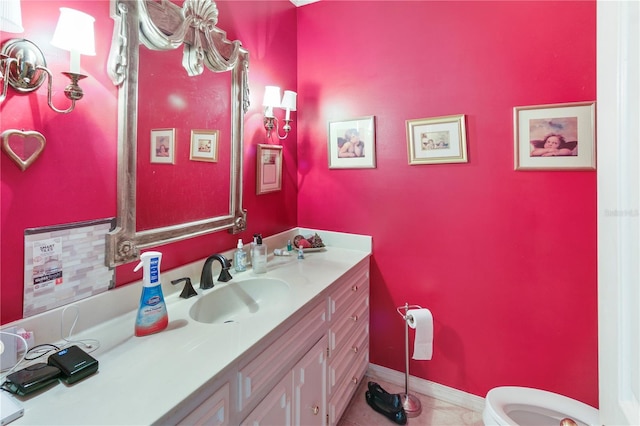 bathroom with tile patterned flooring, toilet, vanity, and baseboards