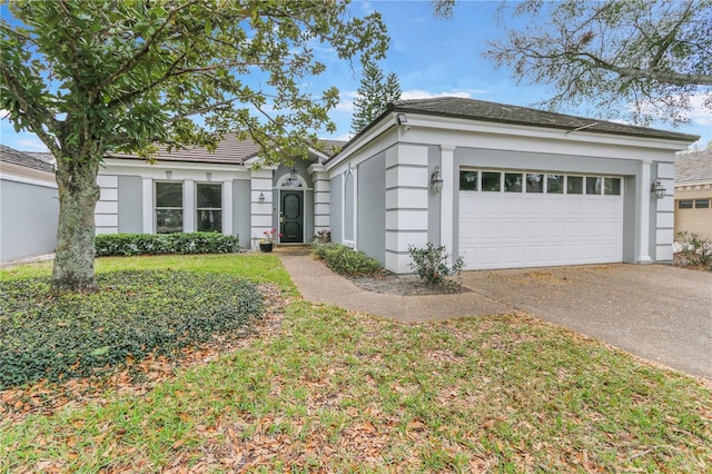 view of front of property featuring a garage, driveway, and stucco siding