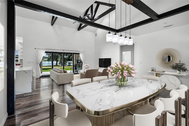 dining room featuring high vaulted ceiling, beamed ceiling, and wood finished floors