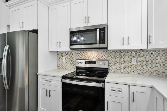 kitchen with stainless steel appliances, decorative backsplash, light stone countertops, and white cabinets