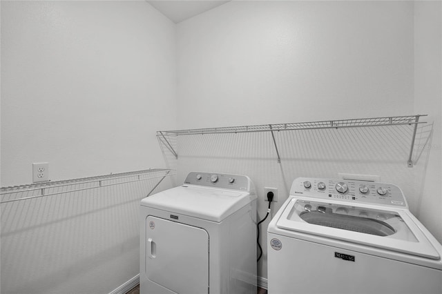 washroom featuring laundry area and washing machine and clothes dryer