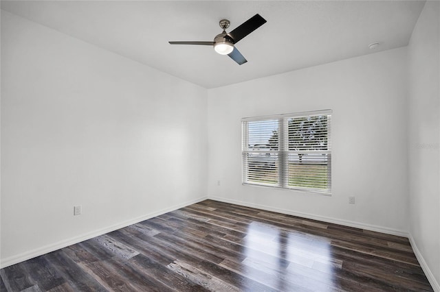 unfurnished room featuring ceiling fan, wood finished floors, and baseboards