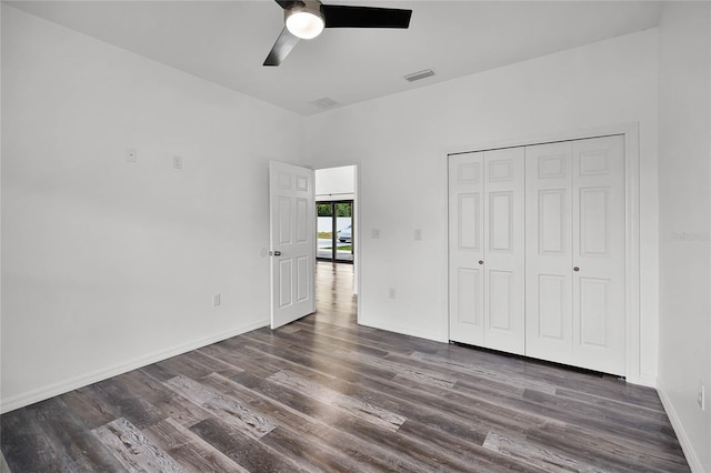 unfurnished bedroom with a ceiling fan, visible vents, baseboards, and wood finished floors