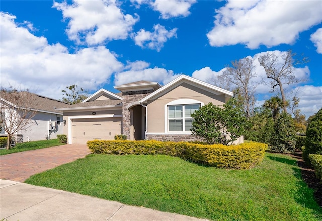 view of front facade with decorative driveway, stucco siding, an attached garage, a front yard, and stone siding