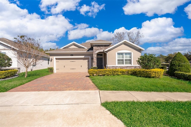 view of front of home featuring stone siding, a front lawn, decorative driveway, and an attached garage