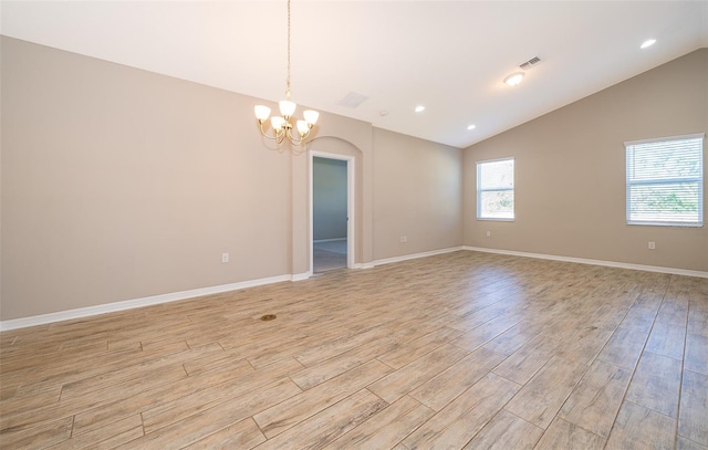 empty room featuring lofted ceiling, visible vents, baseboards, light wood-type flooring, and an inviting chandelier