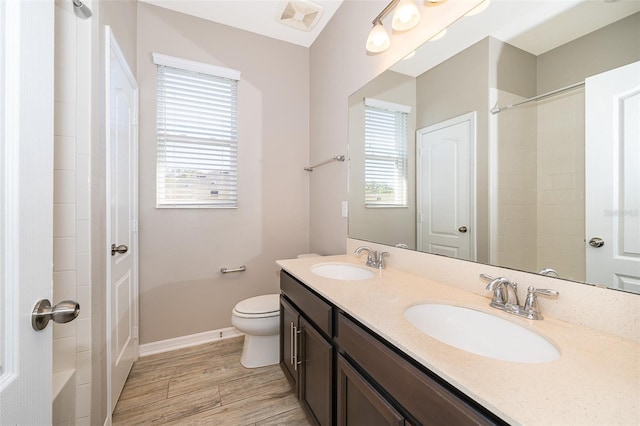 full bathroom featuring visible vents, a sink, baseboards, and wood finished floors