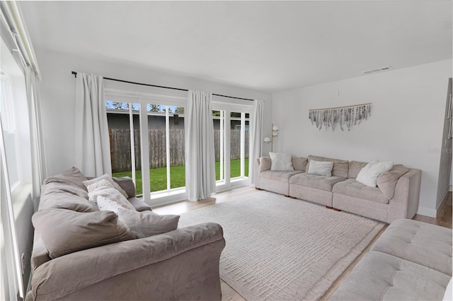 living area with wood finished floors and visible vents