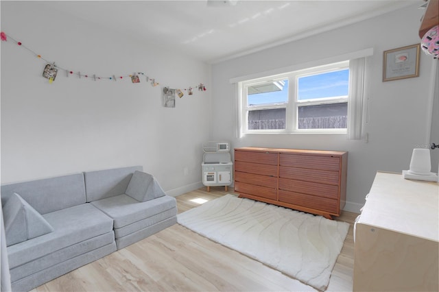 bedroom featuring baseboards and light wood finished floors