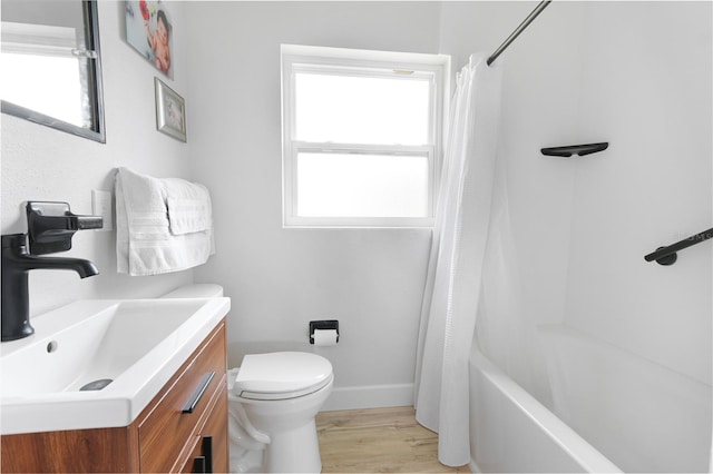 full bathroom with baseboards, toilet, wood finished floors, shower / bathtub combination with curtain, and vanity