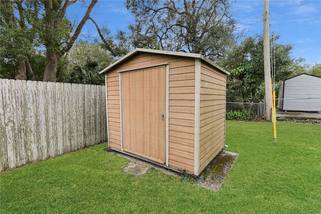 view of shed with a fenced backyard