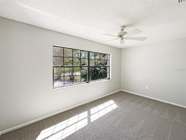 empty room featuring carpet floors, a textured ceiling, baseboards, and a ceiling fan