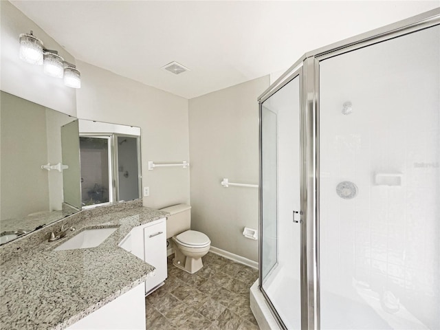 bathroom featuring toilet, vanity, visible vents, baseboards, and a shower stall